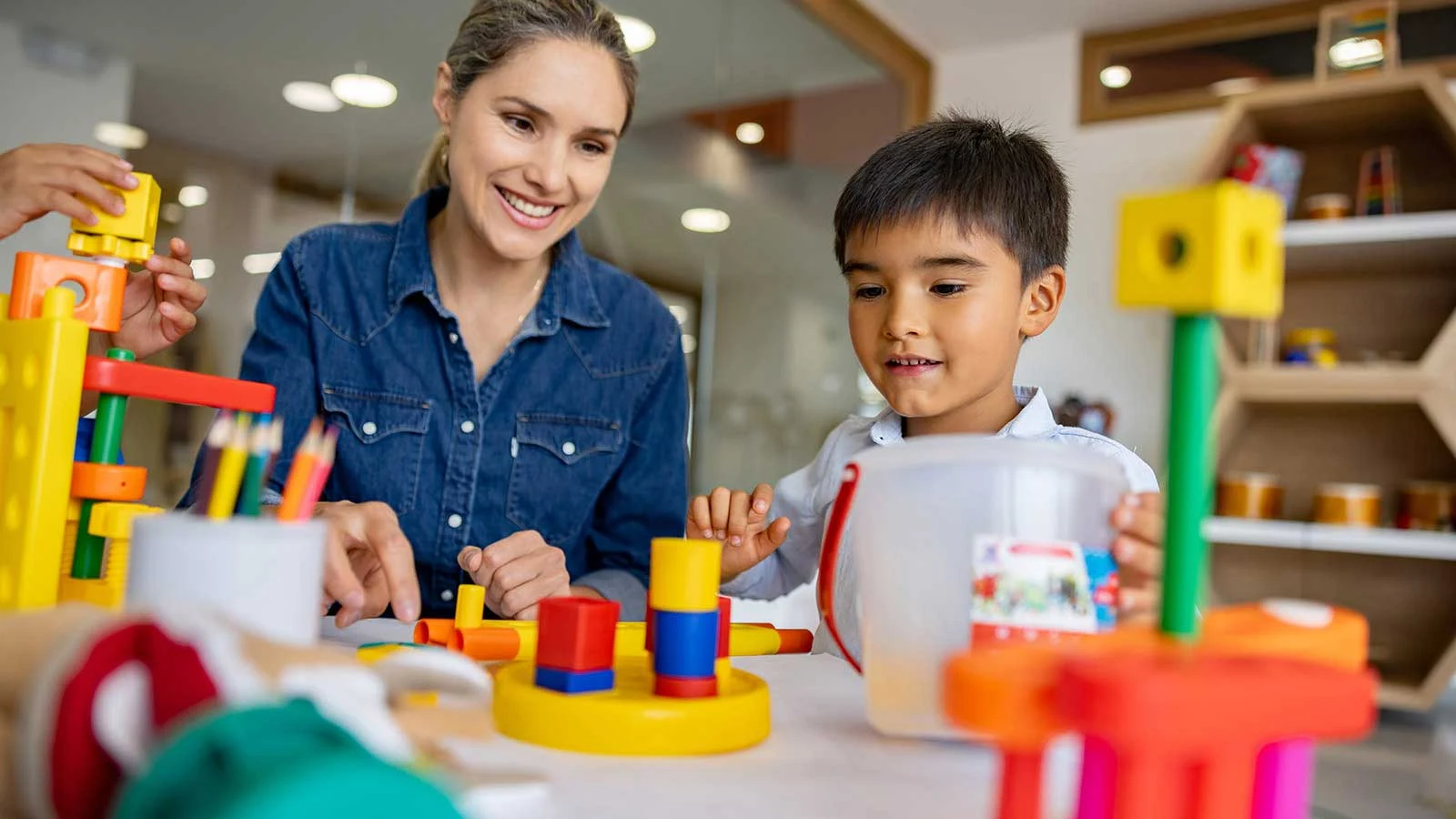 Therapist and child playing together on the floor